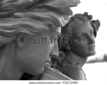 Young male carved statue glancing over at a young female carved statue. Old Town, Quebec City, Quebec, Canada.