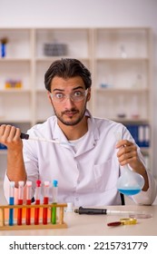 Young Male Chemist Working At The Lab