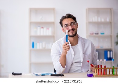 Young Male Chemist Working At The Lab