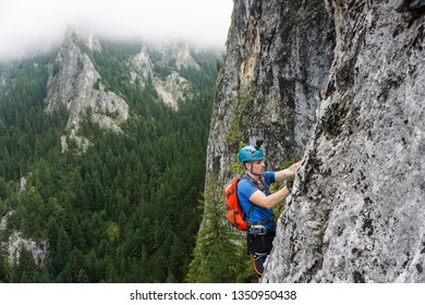 Young Male Climber Climbing Via Ferrata Astragalus, Romania, Europe In Summer