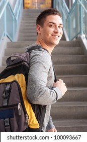 Young Male College Student At School With Backpack