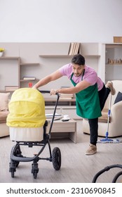 Young male contractor cleaner looking after newborn - Shutterstock ID 2310690845