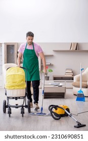 Young male contractor cleaner looking after newborn - Shutterstock ID 2310690851