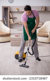 Young male contractor cleaning the house - Shutterstock ID 2310718487
