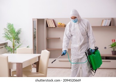 Young Male Contractor Disinfecting At Home