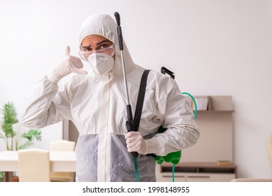 Young Male Contractor Doing Pest Control At Home