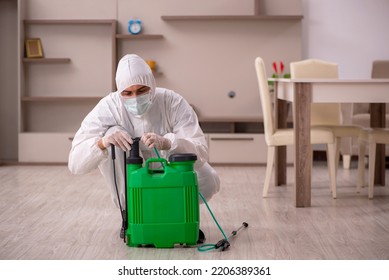 Young Male Contractor Doing Pest Control At Home