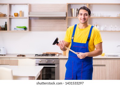 Young male contractor repairing tap at home  - Shutterstock ID 1431533297
