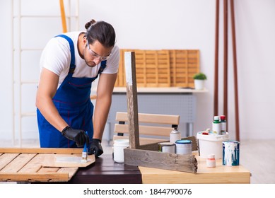 Young male contractor working in workshop - Powered by Shutterstock