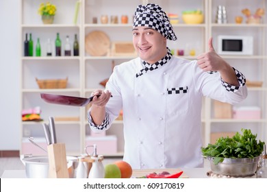 Young male cook working in the kitchen - Shutterstock ID 609170819