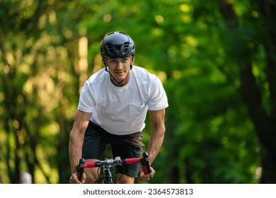 Young male cyclist riding a bike in the forest