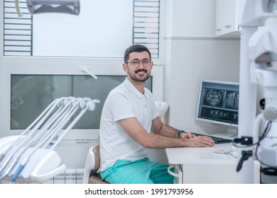 Young Male Dentist At His Office Looking Busy