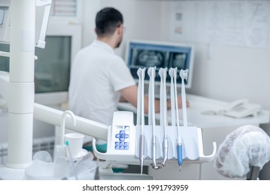 Young Male Dentist At His Office Looking Busy