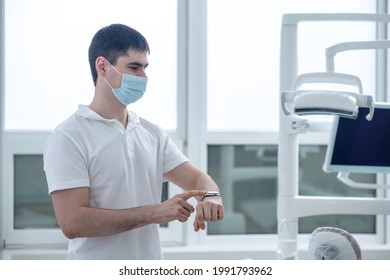 Young Male Dentist At His Office Looking Busy