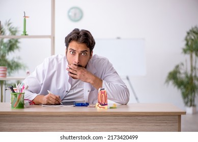 Young Male Dentist Working In The Clinic