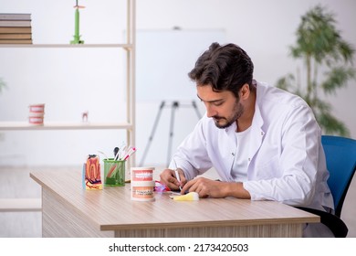 Young Male Dentist Working In The Clinic