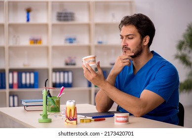 Young Male Dentist Working In The Clinic