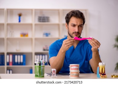 Young Male Dentist Working In The Clinic