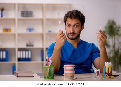 Young Male Dentist Working In The Clinic