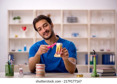 Young Male Dentist Working In The Clinic