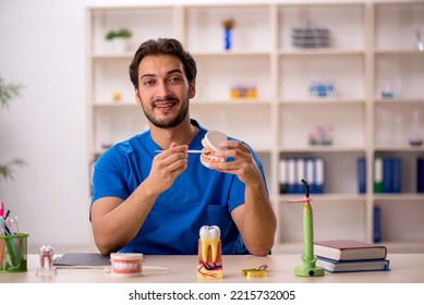 Young Male Dentist Working In The Clinic