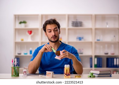 Young Male Dentist Working In The Clinic