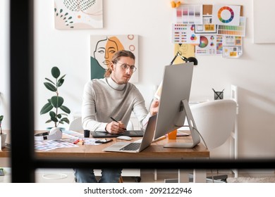 Young Male Designer Working In Office