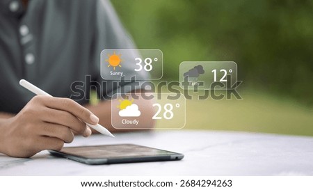 Young male developer using stylus on tablet to check augmented reality weather forecast UI outdoors; sunny, rainy, cloudy temperatures; smart technology and mobile app concept.