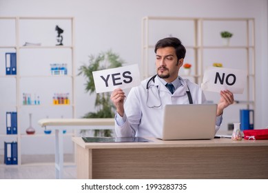 Young Male Doctor In Decision Making Concept