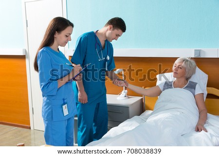 Similar – Female doctor filling questionnaire to senior patient