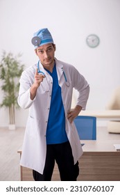 Young male doctor otologist working in the clinic - Shutterstock ID 2310760107