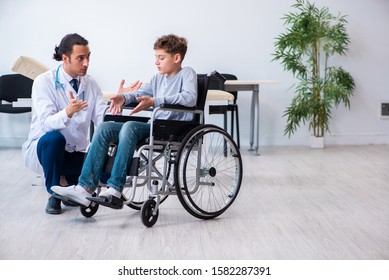 Young male doctor pediatrist and boy in wheel-chair - Powered by Shutterstock