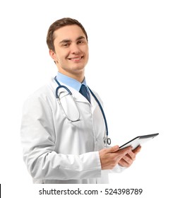 Young male doctor with tablet on white background