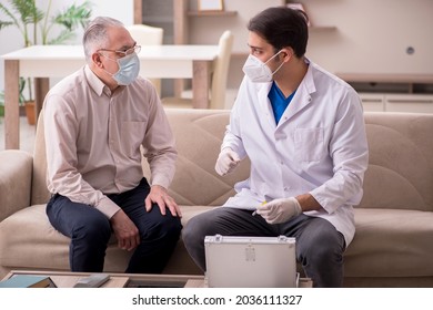 Young male doctor visiting old patient in vaccination concept