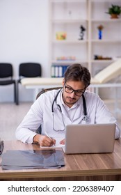 Young Male Doctor Working In The Clinic