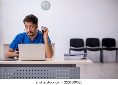 Young Male Doctor Working In The Clinic