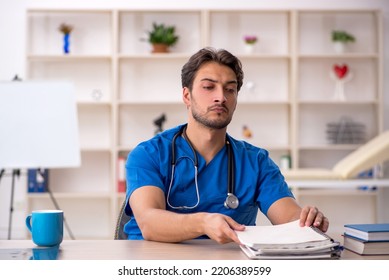 Young Male Doctor Working In The Clinic