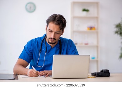 Young Male Doctor Working In The Clinic