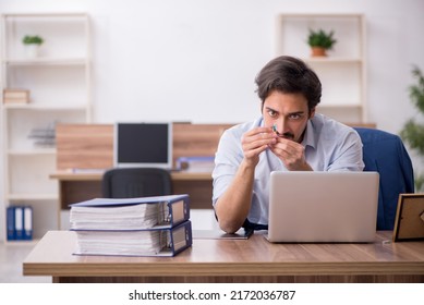 Young Male Drug Addicted Employee At Workplace