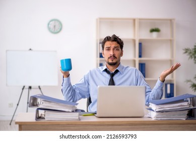 Young Male Employee Drinking Coffee During Break