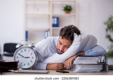 Young male employee in oversleeping concept - Shutterstock ID 2206389383