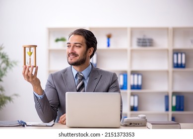 Young male employee in time management concept - Powered by Shutterstock