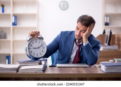 Young male employee in time management concept - Shutterstock ID 2240531347