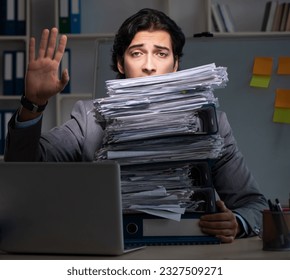 Young male employee working late at office - Powered by Shutterstock