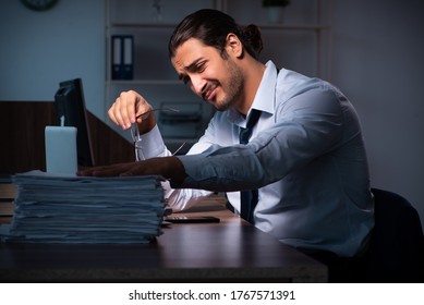 Young Male Employee Working In The Office Night Time