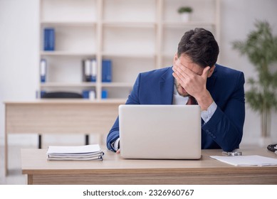 Young male employee working in the office - Powered by Shutterstock