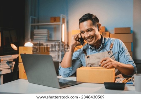 Young male entrepreneur selling products online Prepare packing boxes to send to customers. Concept of business man doing e-commerce business on website and social media Sell ​​products online.