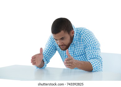 Young male executive pretending to hold an invisible object - Powered by Shutterstock