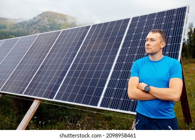 Young Male Farmer Engineer Background Solar Panels In Background With Sun Light.