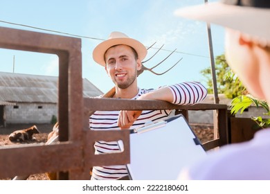 Young Male Farmer In Paddock Outdoors